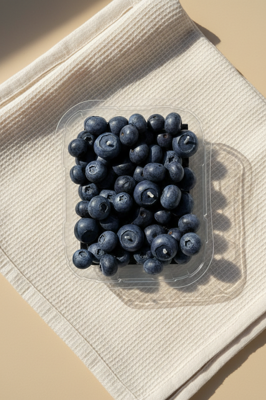 Blueberry punnet on beige linen